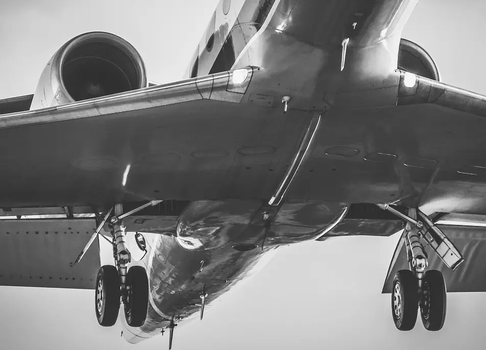 Black and white closeup of plane in the air